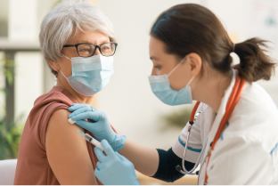 Doctor vaccinating a senior woman